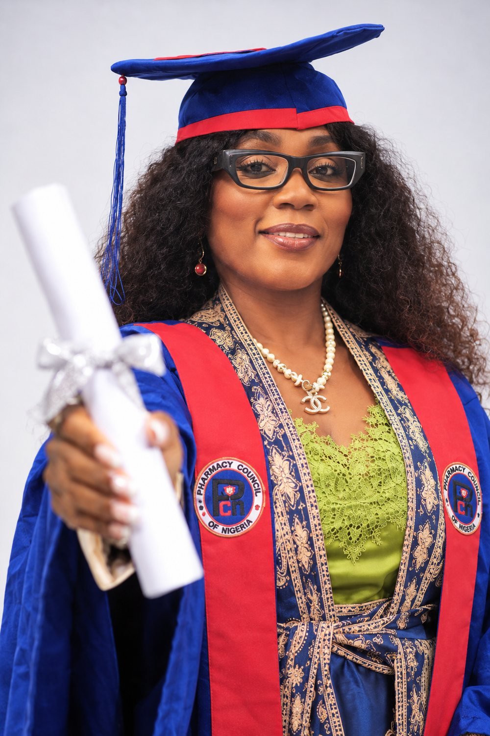 Dr. Ayisat in Pharmacy Council of Nigeria academic regalia, holding a certificate scroll